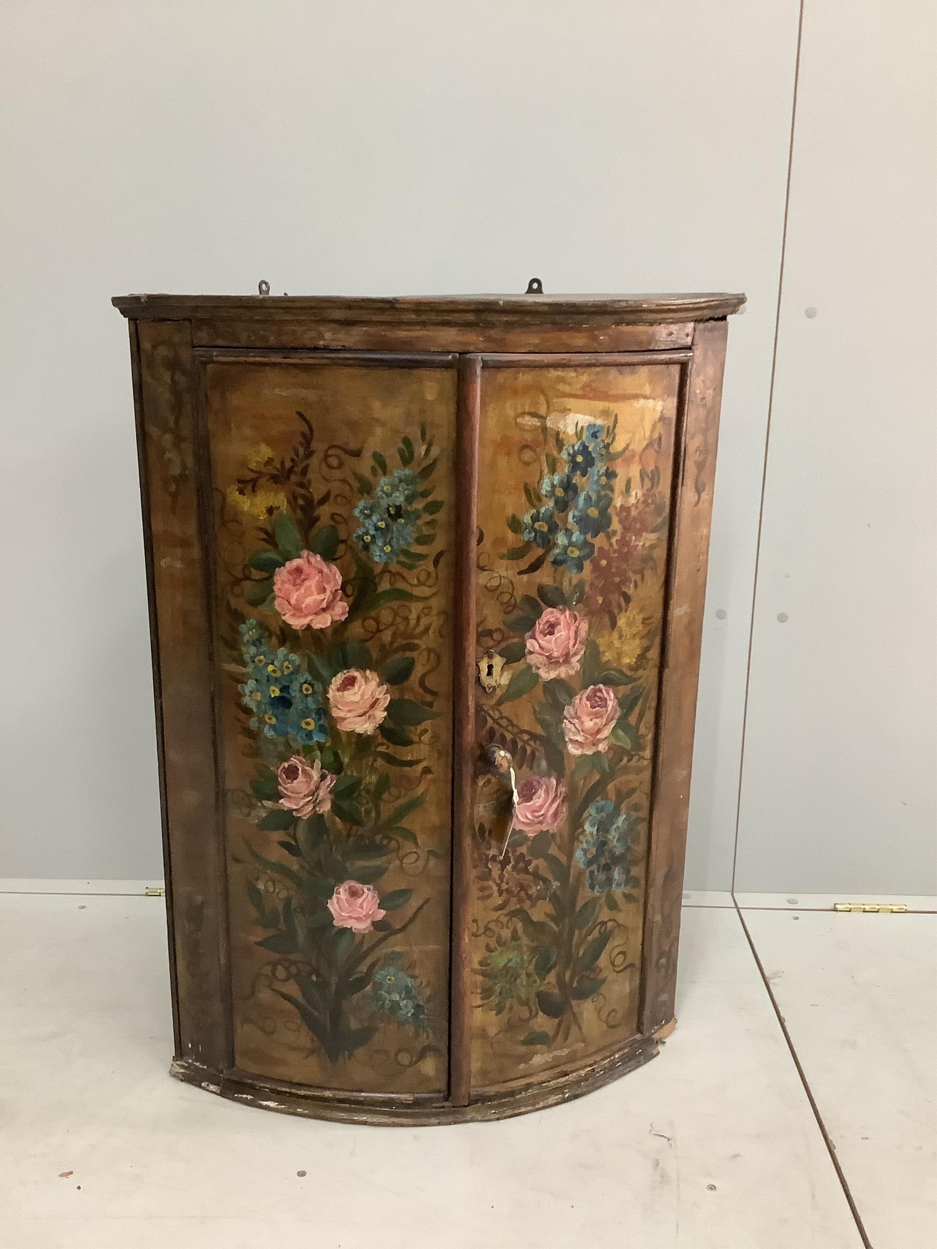 An 18th century Dutch bowfront hanging corner cupboard, later painted, width 66cm, depth 45cm, height 92cm. Condition - fair